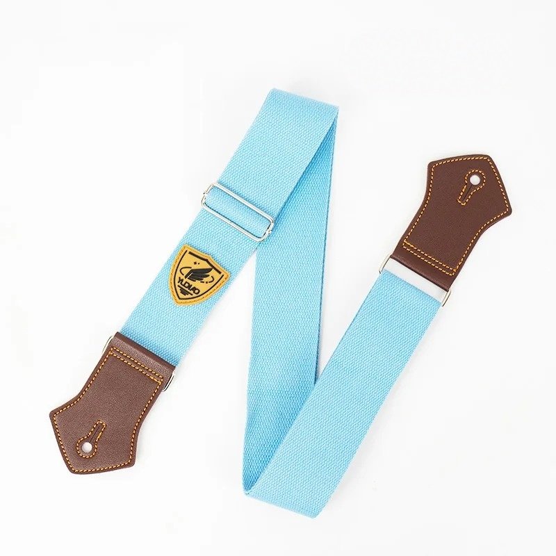 Sangle guitare unie Palette Pop coloris bleu ciel avec embouts en simili cuir brun
